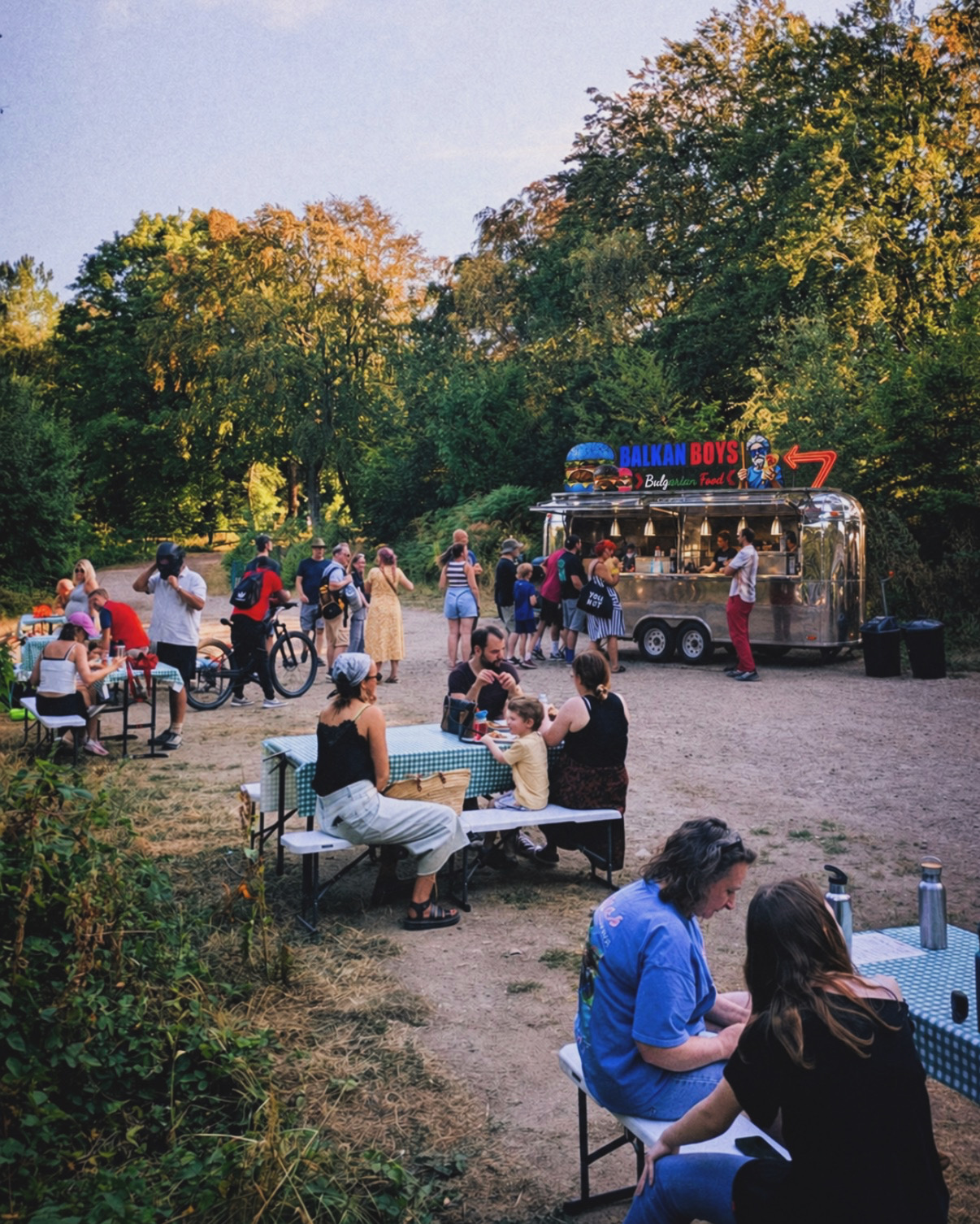 Visitors near the ballkanboyz trailer at an outdoor festival